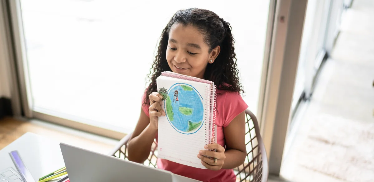 little girl showing a map in front the computer